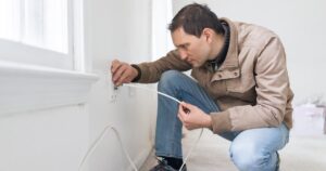 man installing internet in his house