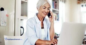 senior woman on phone using laptop