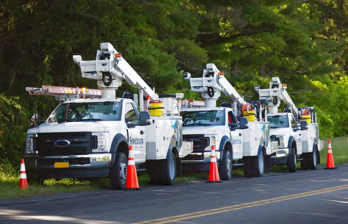 Image of Spectrum vehicles parked along a road