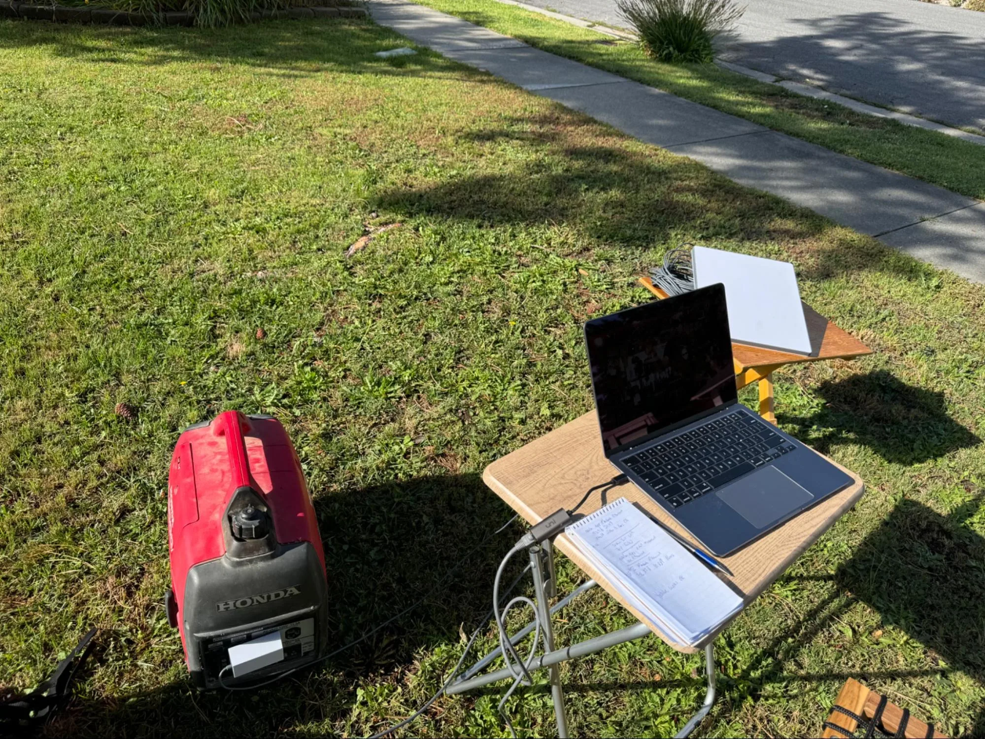 Honda gas generator powers the Starlink Mini dish during a suburban power outage on a hot summer day