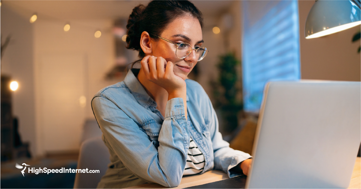 Woman at home searching for an internet service provider on laptop